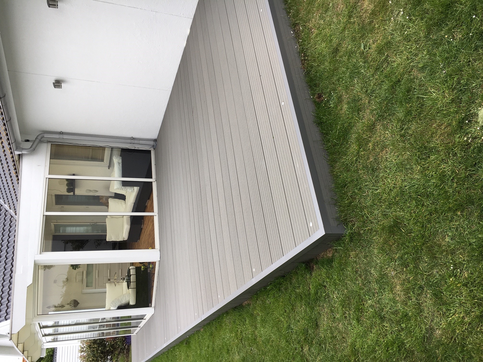 Grey composite terrace with recessed lighting